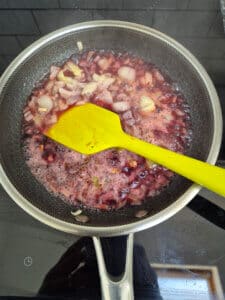 Add red wine and reduce by half