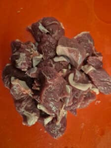 Cut the lamb into chunks, removing excess fat