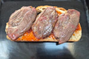 Spicy sauce, then place cooked bacon on top