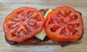 Tomato placed on top of the brie
