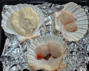 Adding sauce to the scallops shells