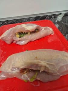 Cut pockets into the chicken breast and fill with the stuffing