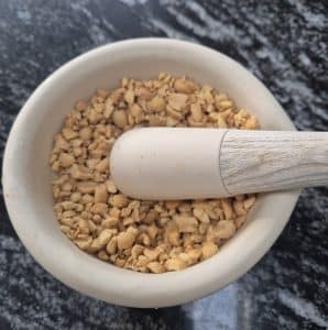 crushed peanuts a a pestle and mortar