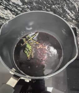Red wine is being reduced in a pan