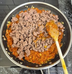 The lamb mince and tomatoes added to the pan with the spices & onions