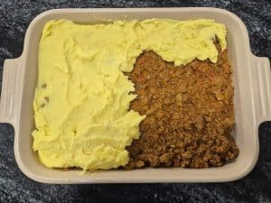 Add the creamy mash on top of the keema mince