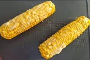 Mayo mixture brushed over the corn of the cobs